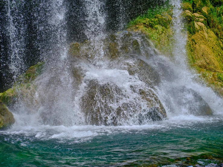 an odd looking waterfall falls out of a pool