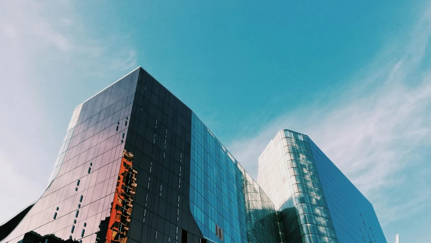 two tall buildings standing on the street next to each other