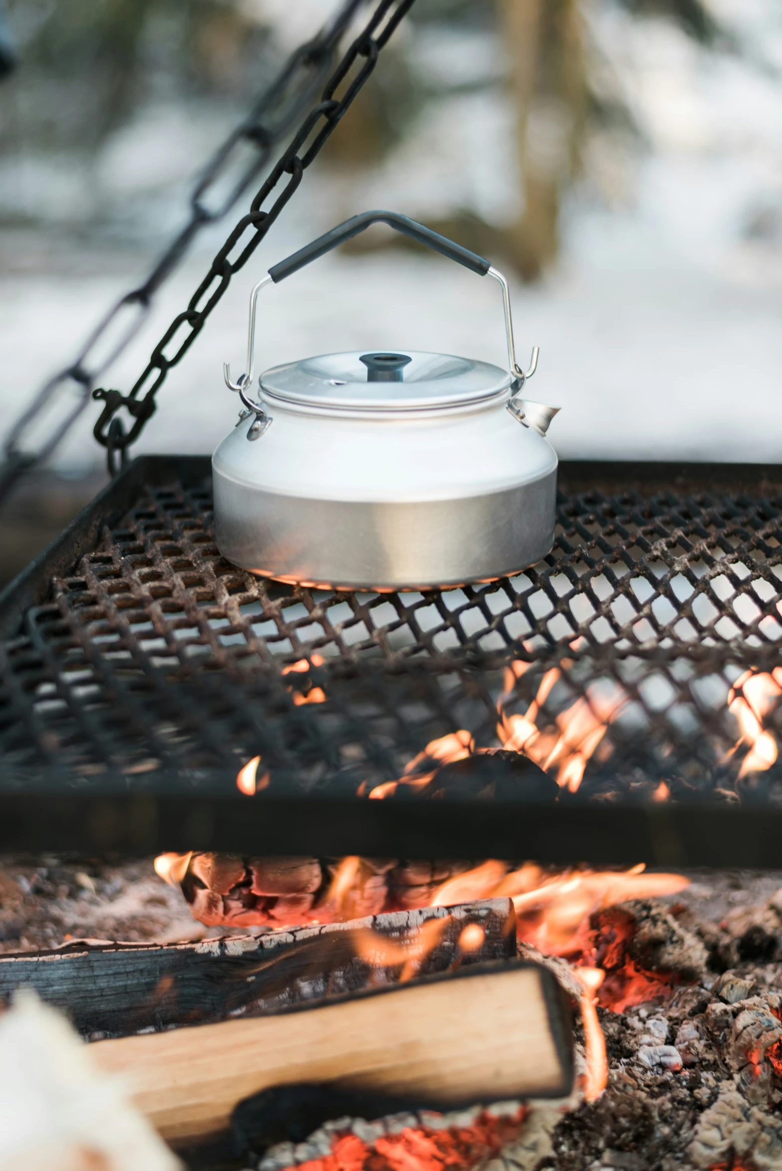 a  pot sitting on top of a camp fire grill