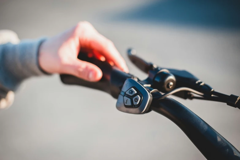 a person holds the handlebars of their bicycle