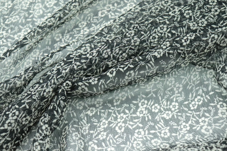 black and white image of two squares of cloth with a pattern