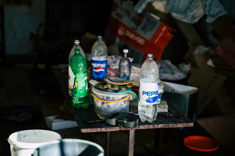 several bottles and cans sitting on an outdoor table