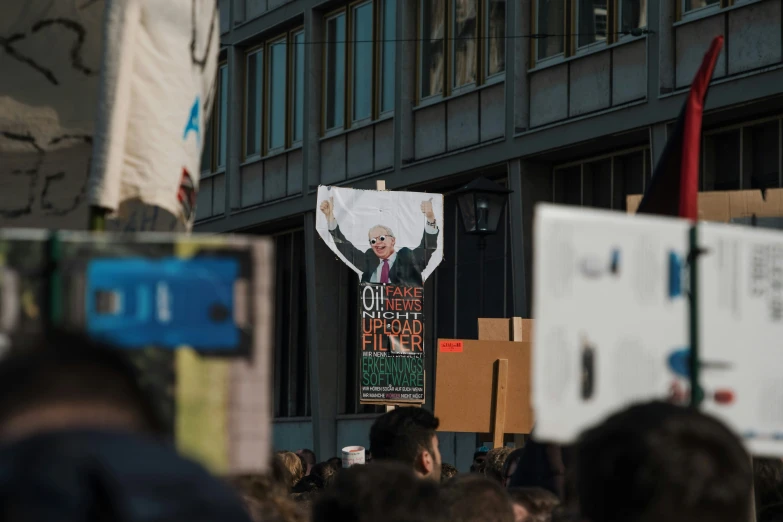there is a rally sign with a political image on it