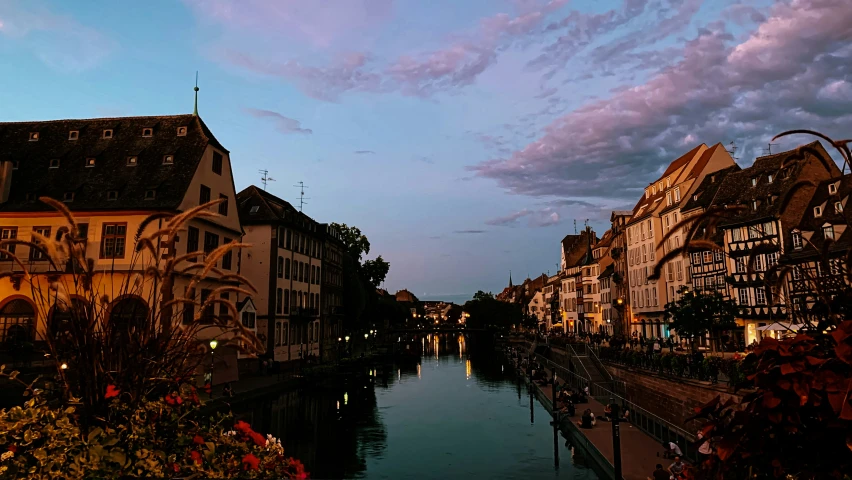 the sky is getting dark over the canal