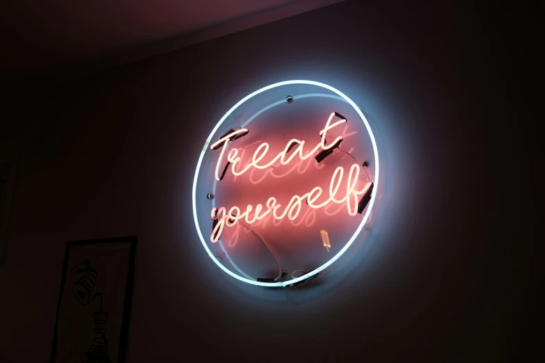 a neon sign that says treat yourself