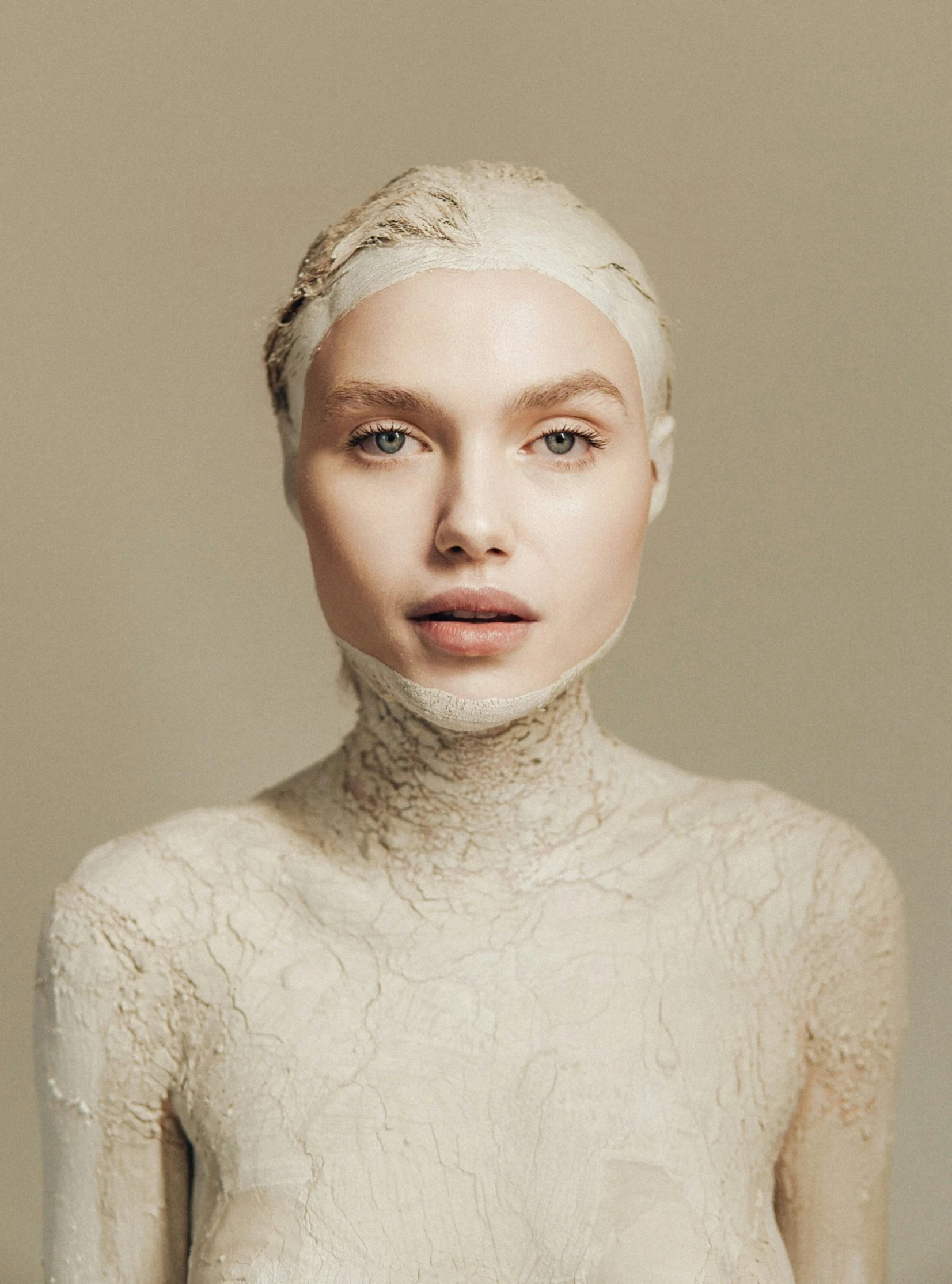 a woman is shown posing with a white face