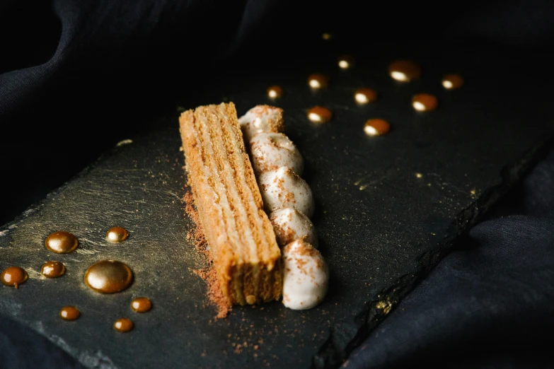 a dessert is on a slate slab of metal