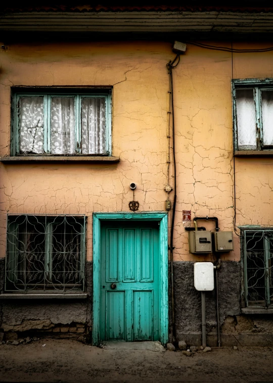 a building with a door and windows sitting next to a street light