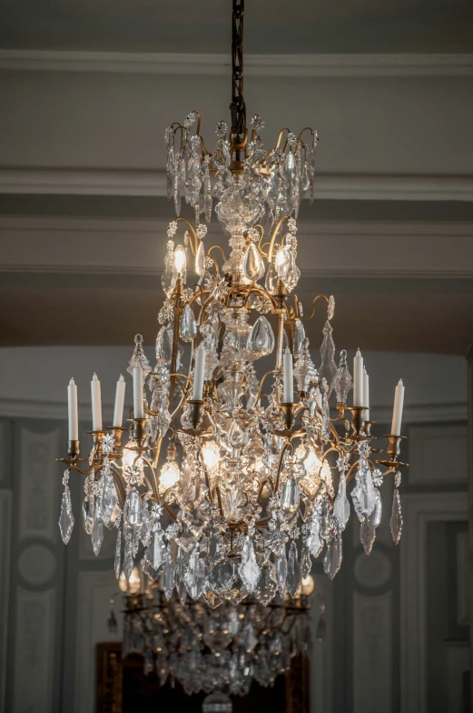 an ornate chandelier is hanging from the ceiling