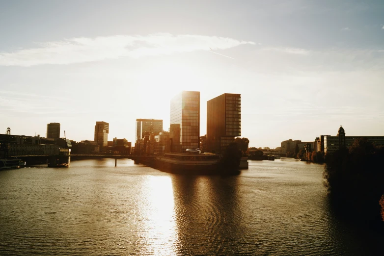 a river in front of tall buildings that have been reflected in it