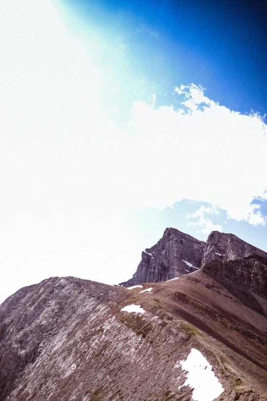 the top of some hills with snow and rocks