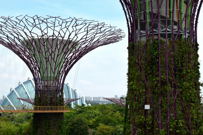 garden with tall metal structure and trees on either side