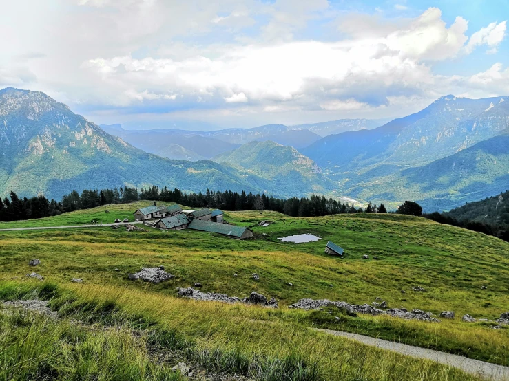 the view of some mountains from a hillside