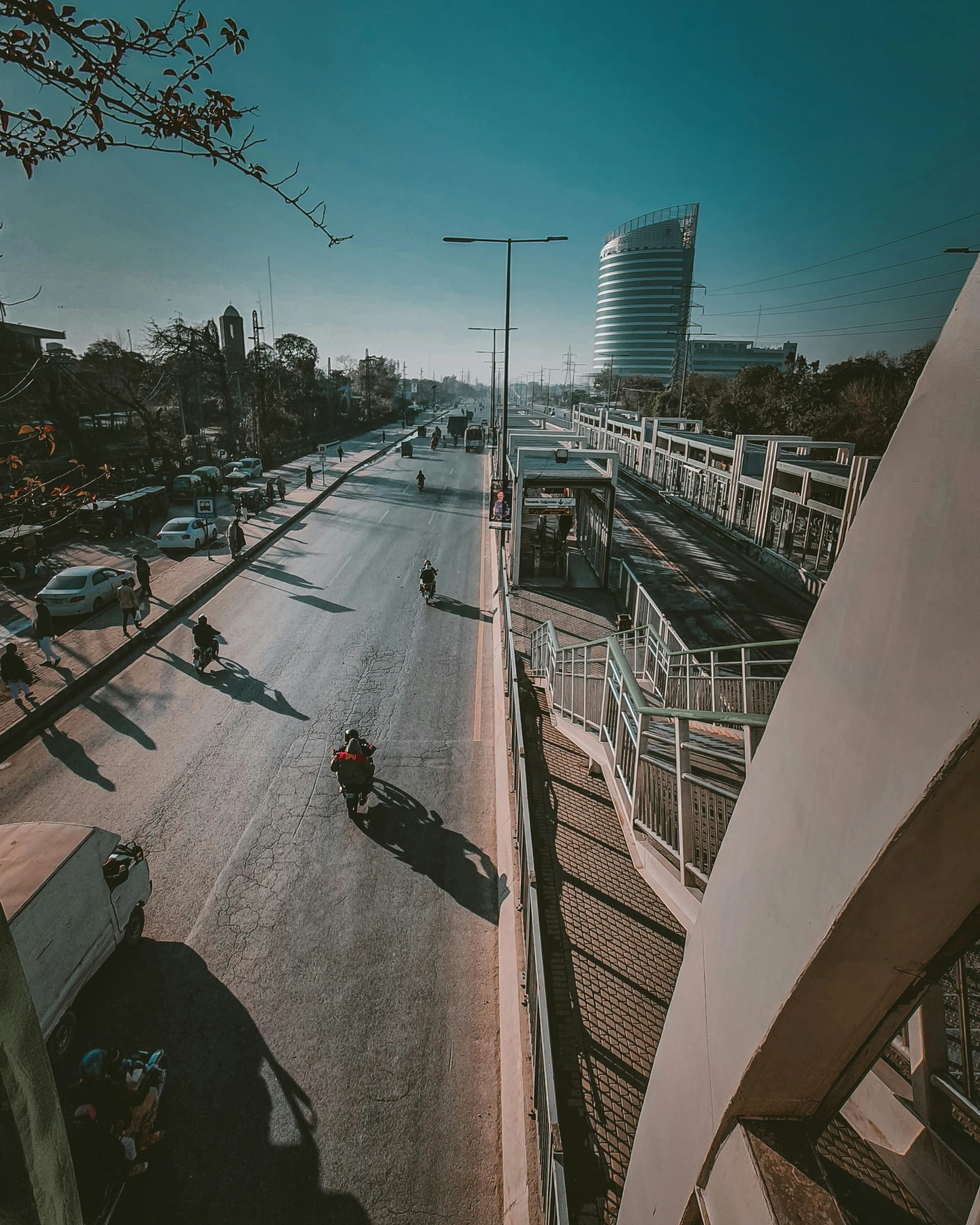 a motorcyclist rides in the middle of an empty street