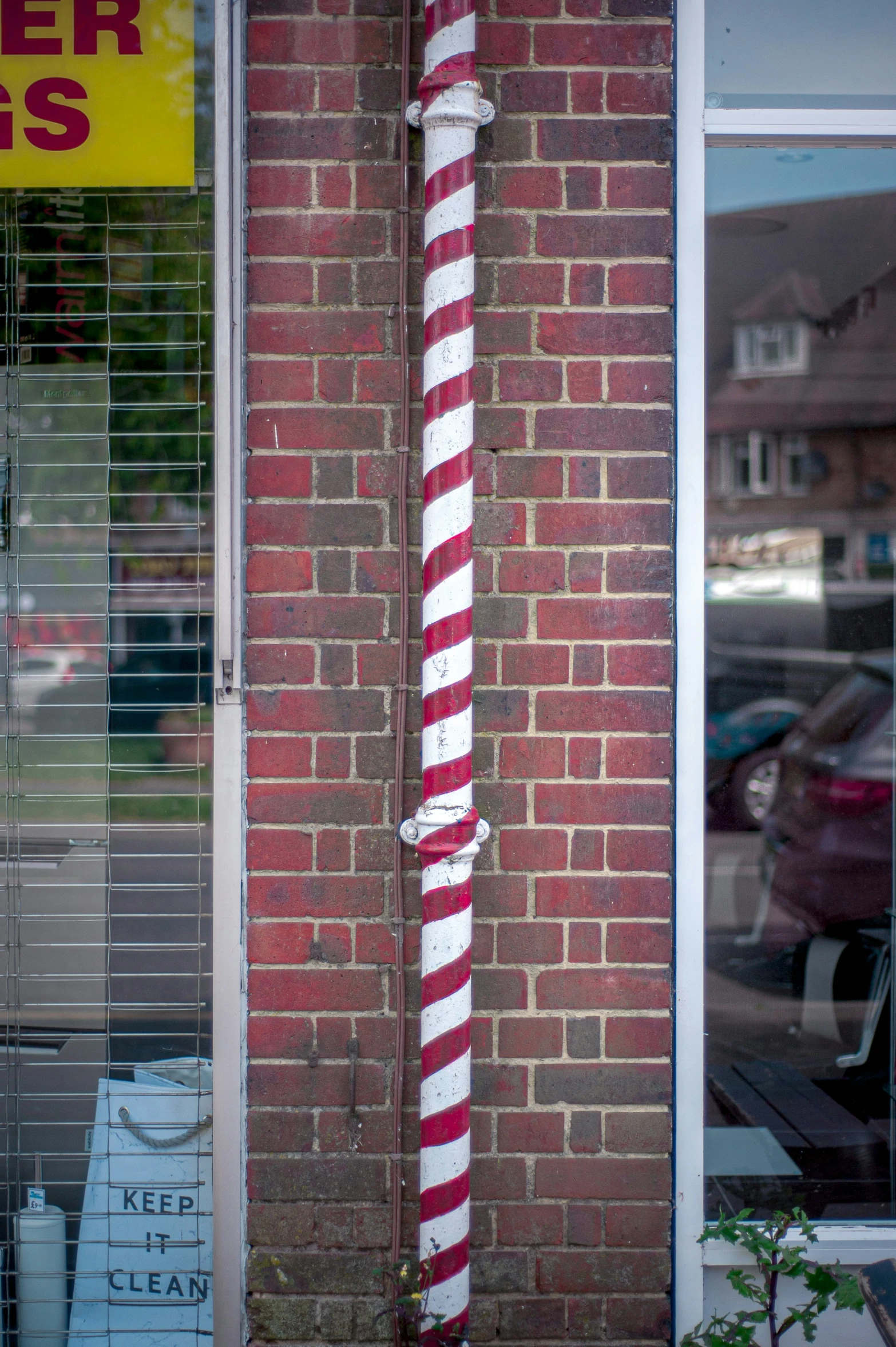 a red brick building has white striped decorations on the side