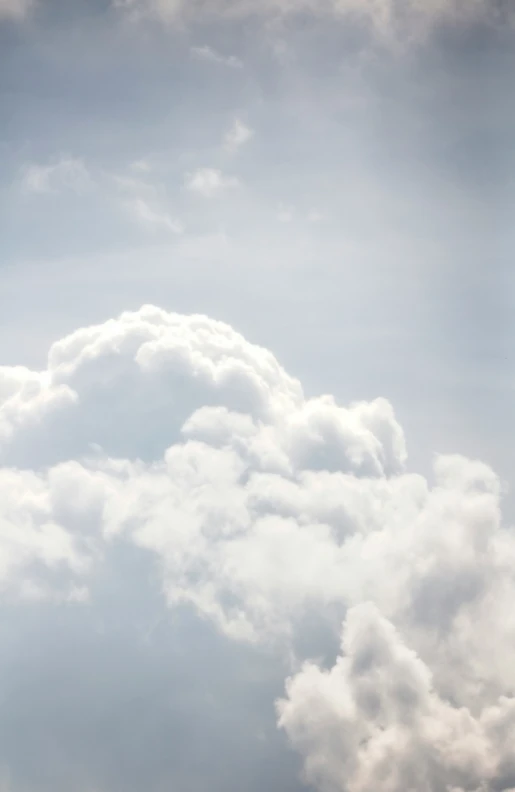 the plane is flying low by the clouds