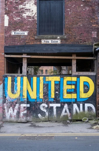 a red brick building with the word united painted on it