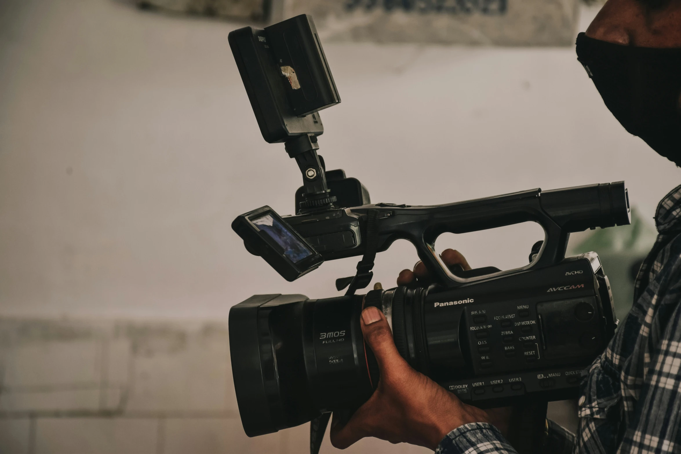 man holding a camera with a full body on tripod