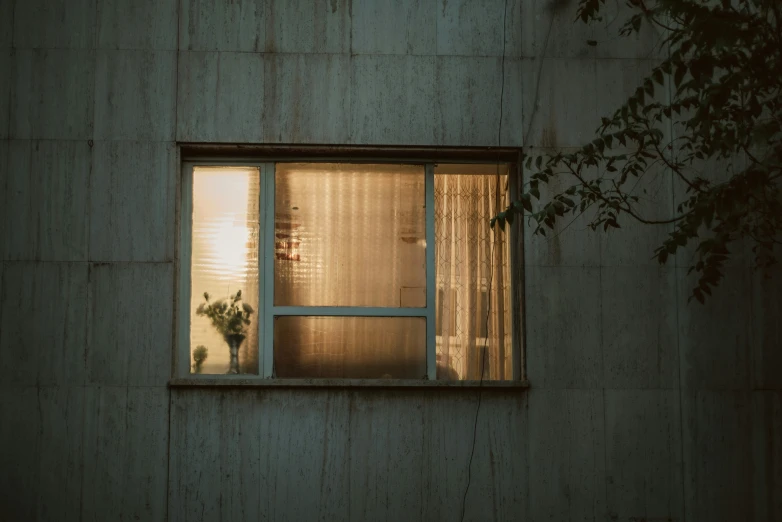 the window of a concrete building has been opened for light