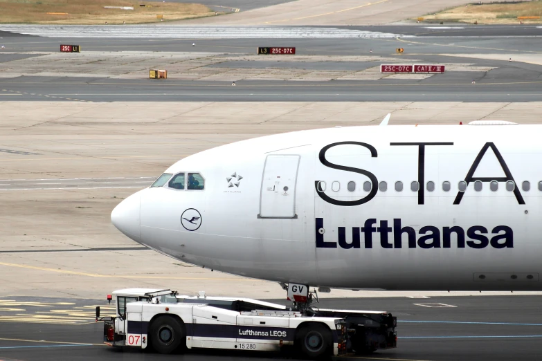 a large commercial airplane on the runway of an airport