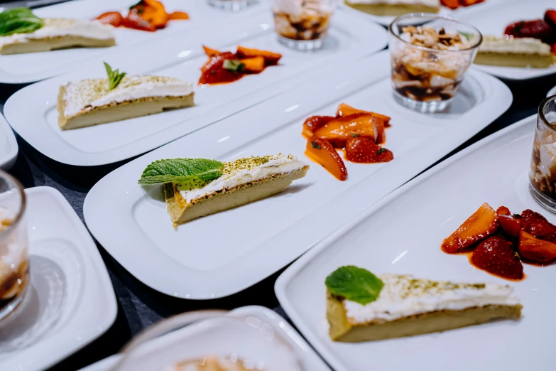 desserts and dessert plates are arranged on a table