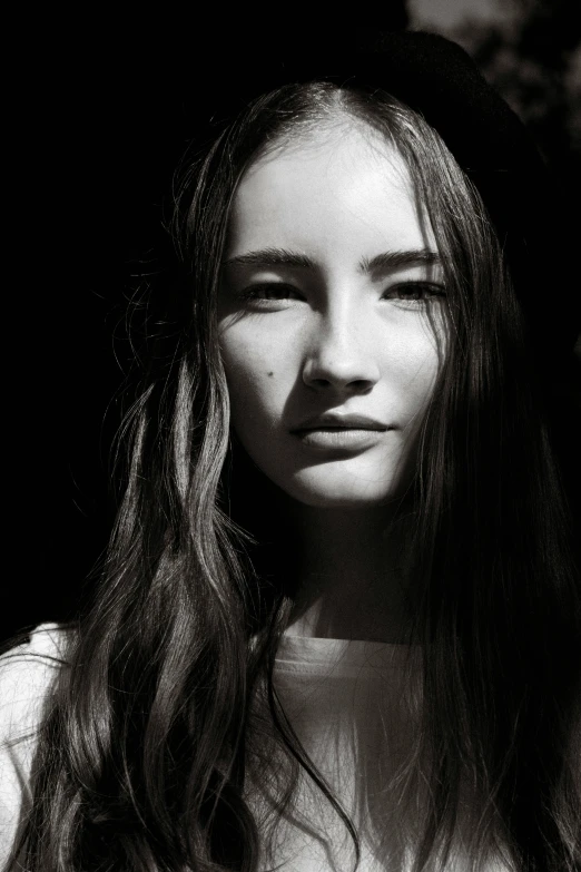 a young woman with long hair is looking directly in the camera