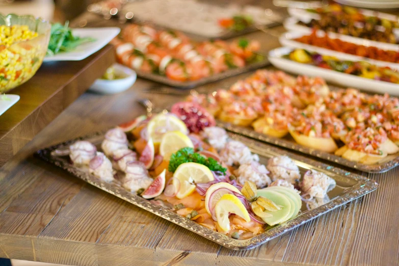 food on trays in a buffet setting with meat and vegetables