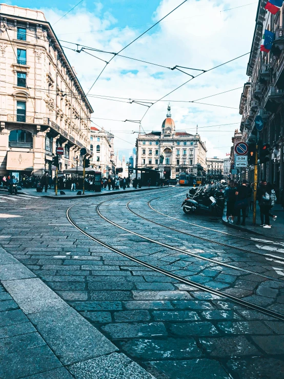 street intersection with cars and people and buildings in the background