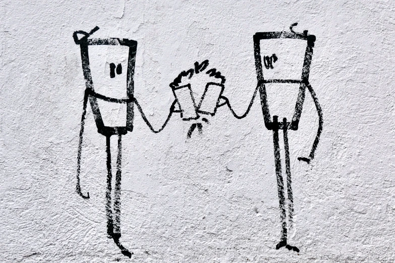 two people holding hands next to each other, drawn on a wall