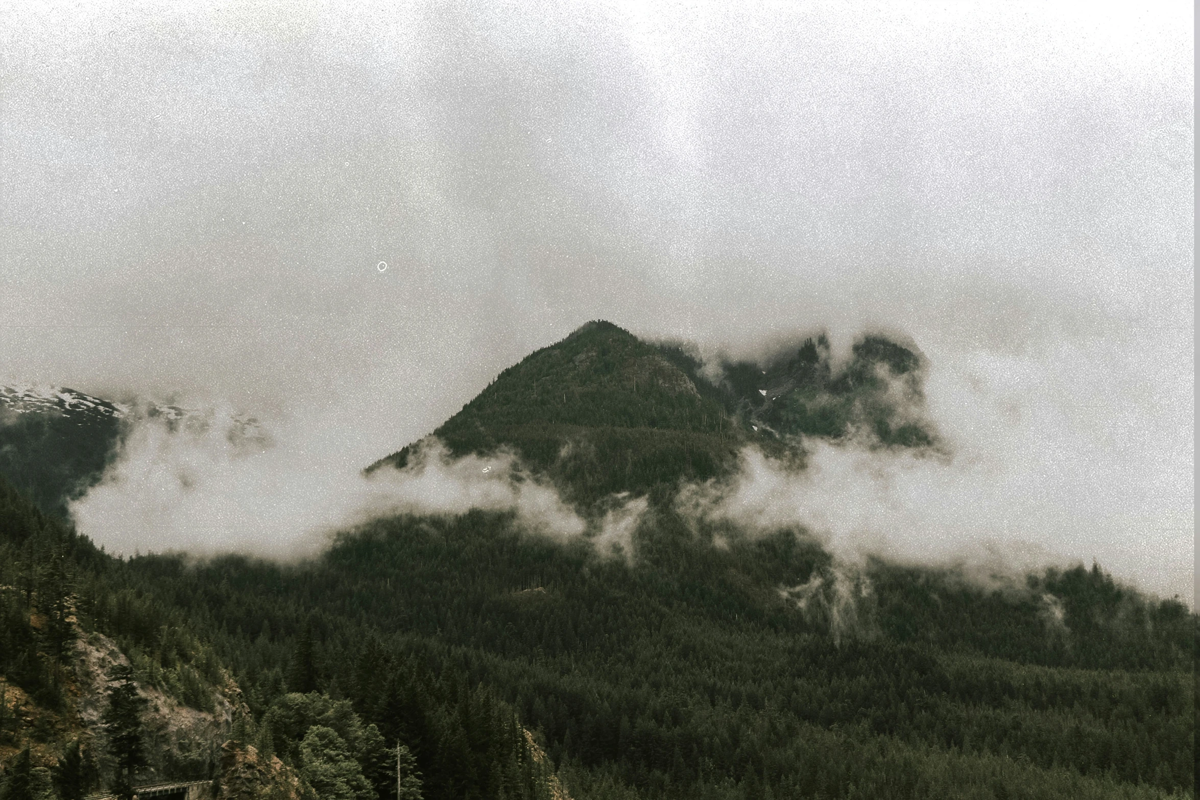 clouds move over the tops of a mountain