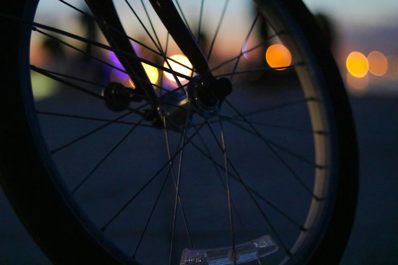 bike wheels at dusk with street lights