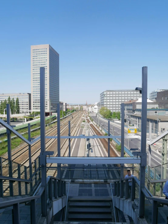 looking down at the top of an escalator in a railway crossing