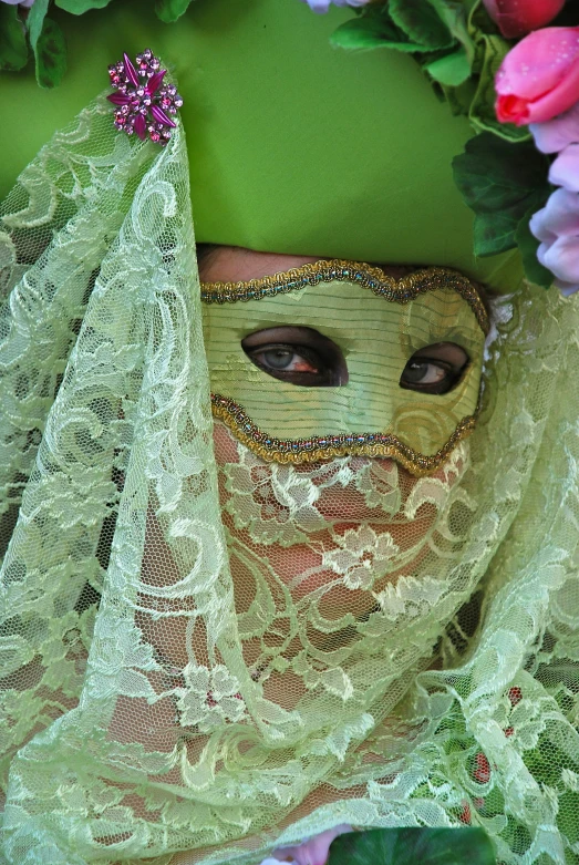 a woman wearing a mask, dress and flowers