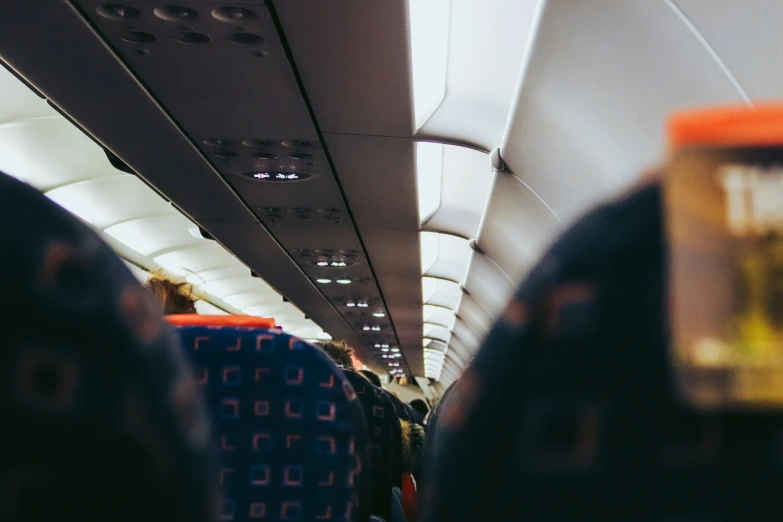 this is a po taken from inside the airplane with people sitting in the aisle