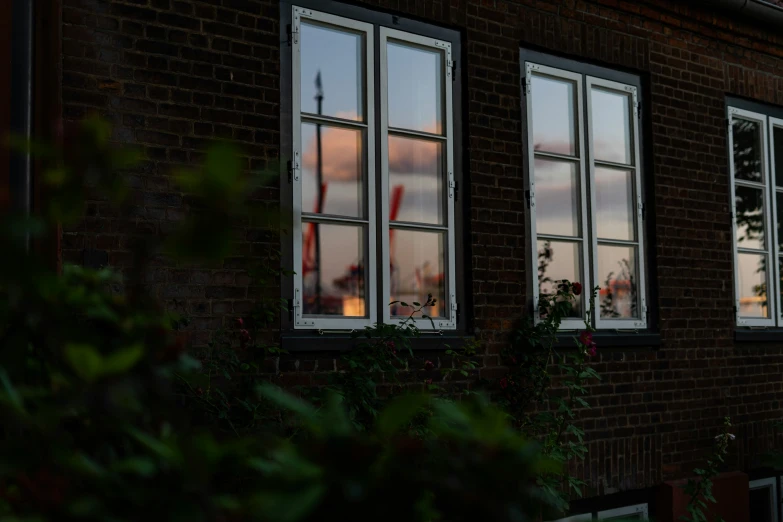 windows in the side of a brick building lit up with bright lights