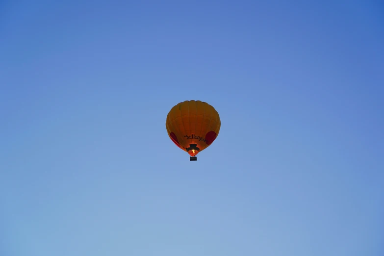 the sky is bright blue and has a  air balloon in it