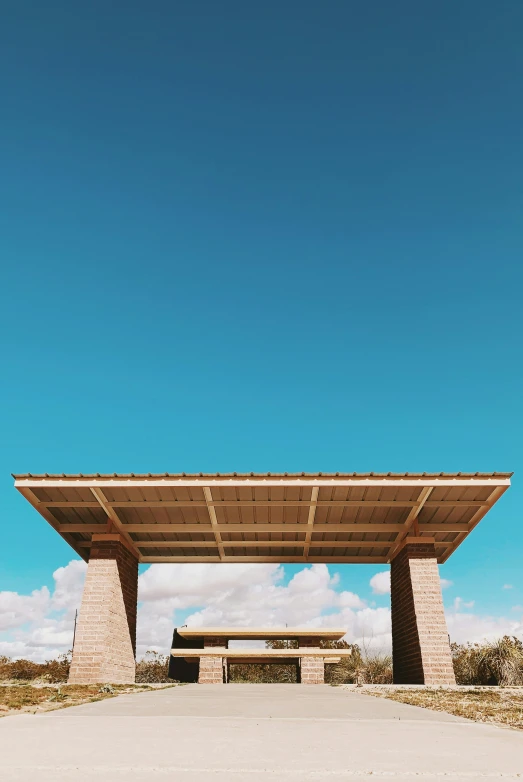 a building with a bench underneath it and a blue sky