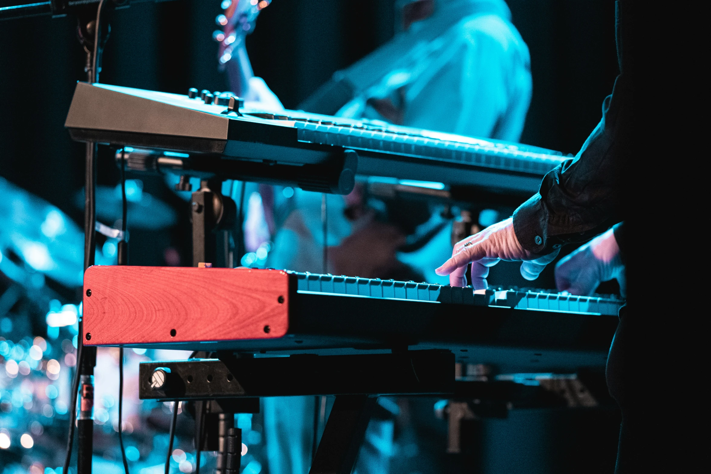 two musicians are playing instruments in front of a stage