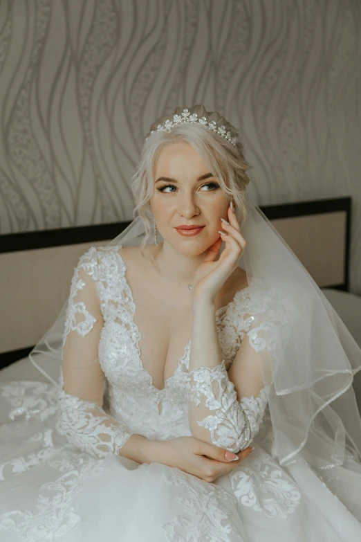 a bride is dressed in white and has makeup on her face