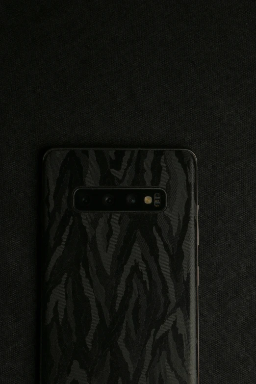a black and white phone is on the black surface