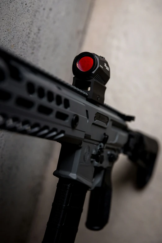 a close up of a gun with an illuminated red dot on it