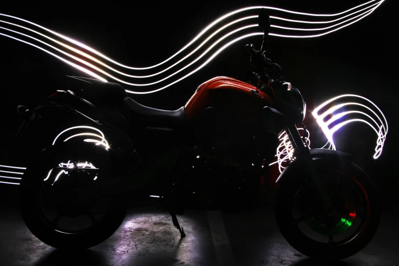 a lit up motorcycle in the dark with the lights on