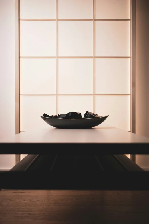 a plate with a black design on it sitting on top of a table