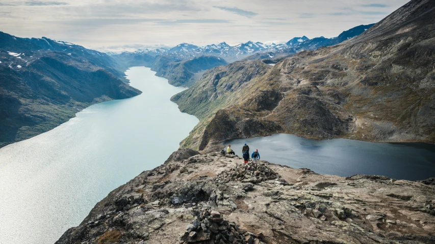 a group of people standing on the edge of a cliff