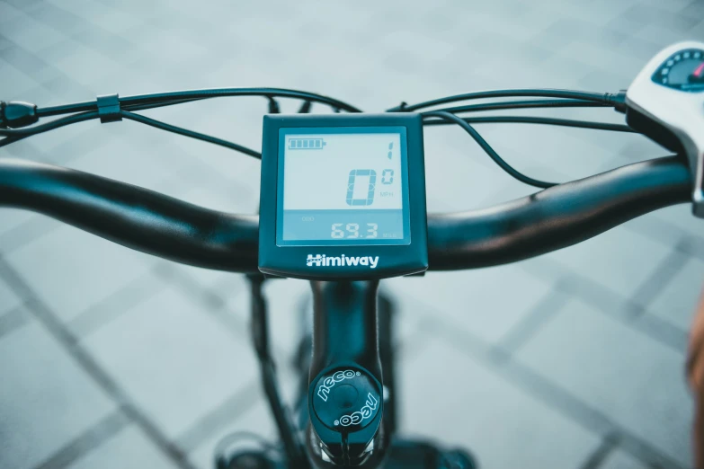 an electronic bike meter is attached to a handlebar