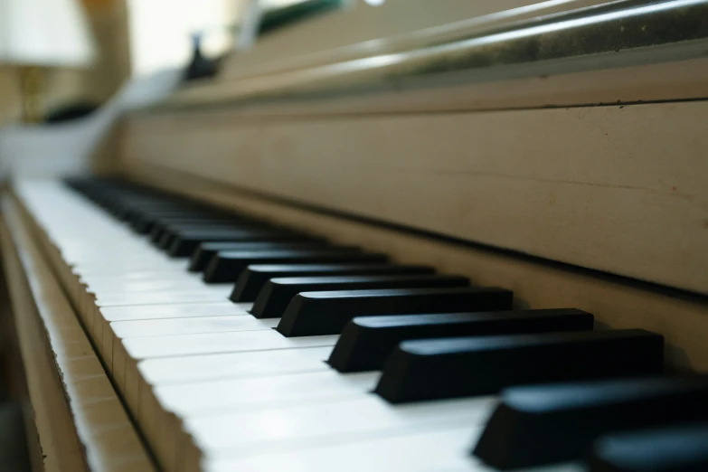 an upright piano with dark keys that have been left to use