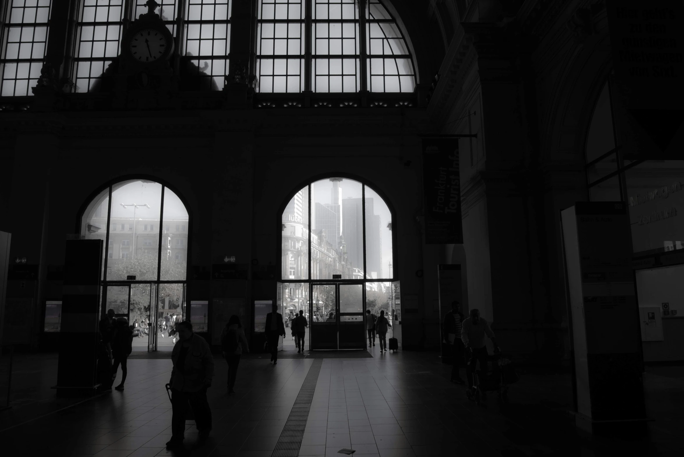 the silhouette of people are walking in a building