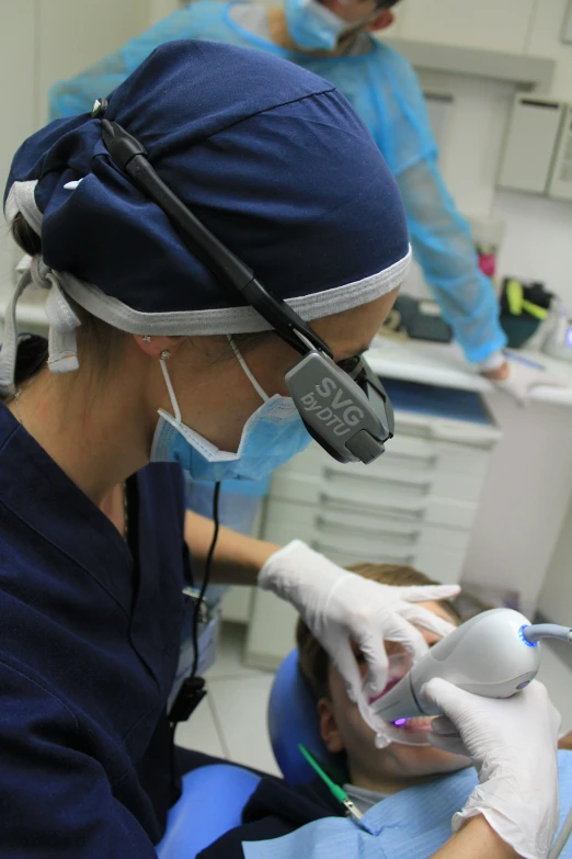 a female doctor examines a female patient's dental chart