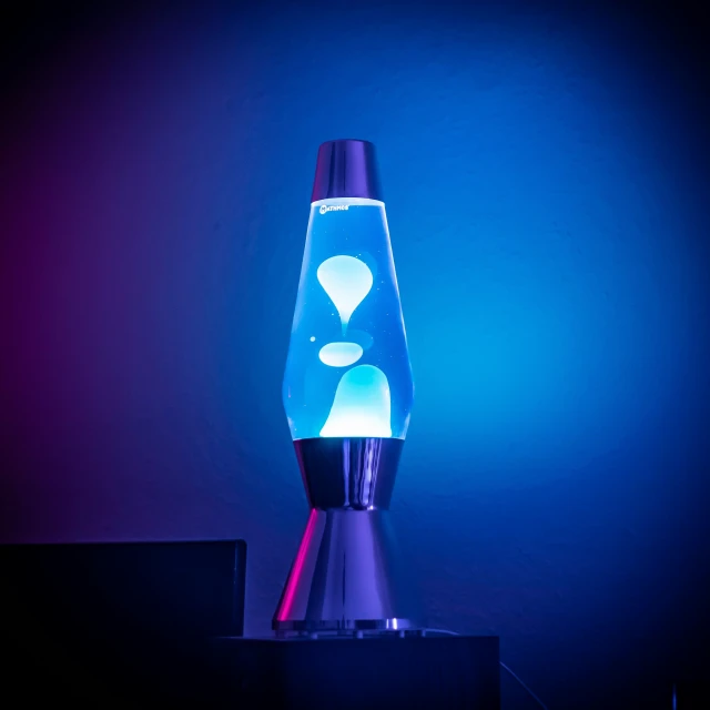 a blue and purple lamp lit up in the dark