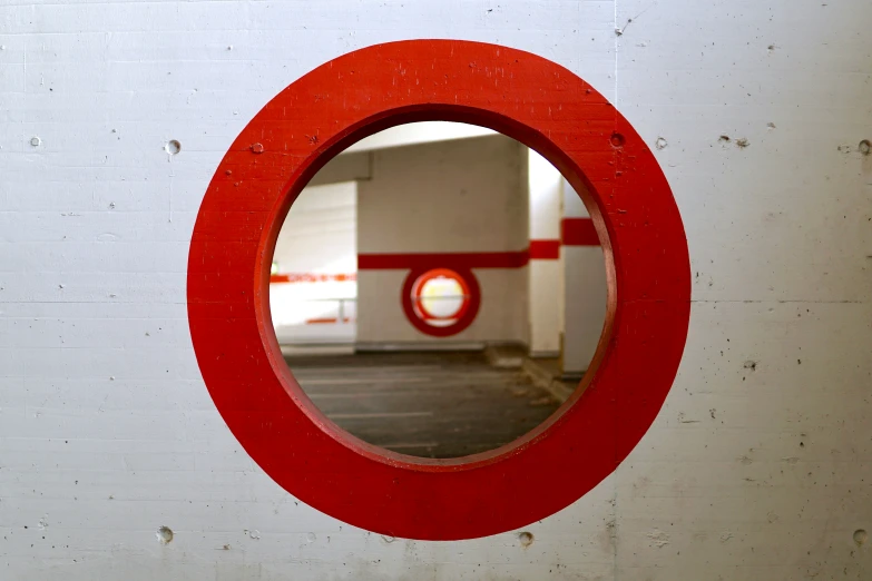 a reflection in a circle mirror near a building